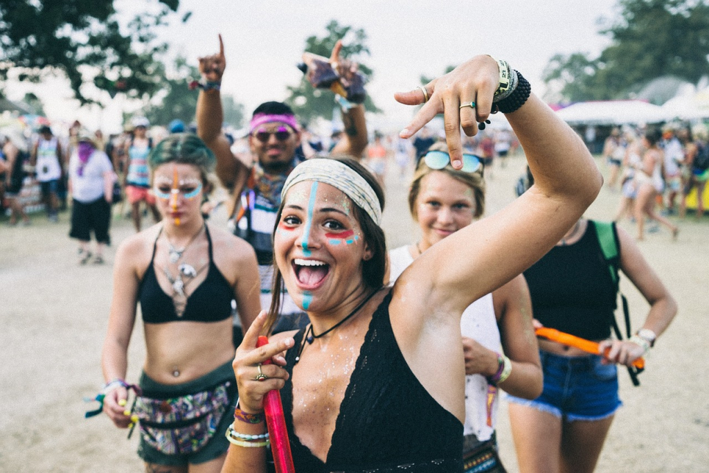 Jugendliche auf einem Festival, bemalt mit verschiedenen Farben